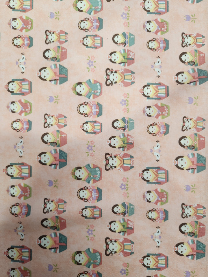 Printed cotton by Super Cheap Fabrics, named Authentic Pink - 113cm, features rows of kokeshi dolls in various traditional Japanese attire on a peach-colored background adorned with small flowers. Each cute, cartoon-like doll holds different accessories, making it perfect for crafting or as inspiration for your 100% cotton quilting projects.