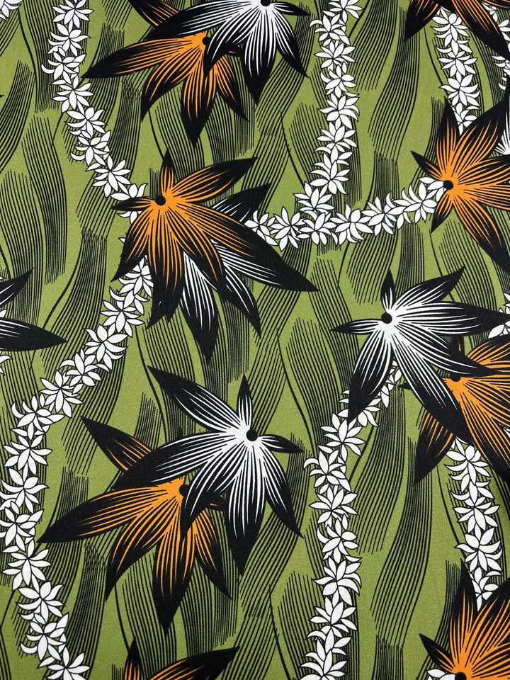 The "Printed Crepe - Wild Hemp - 150cm" by Super Cheap Fabrics showcases a lively design with large, abstract star-shaped flowers in black, white, and orange set against a green polyester crepe fabric. Wavy lines and small white flowers add dynamic movement, enhancing contrast and texture, making it ideal for high-fashion applications.