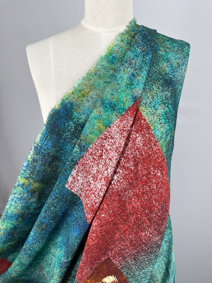 The mannequin features Super Cheap Fabrics' "Linen Blend - Fields - 150cm," showcasing a textured, breathable design in vivid blue-green and red with rough abstract edges for an artistic look, displayed against a neutral gray background.