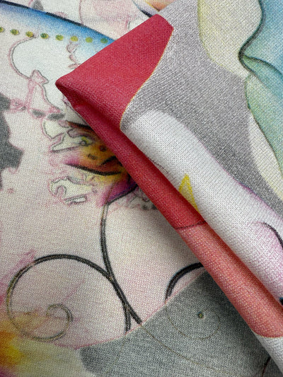 Close-up of Super Cheap Fabrics’ Viscose Knit - Watercolour Bloom (142cm): a lightweight, stretch fabric with a smooth, slightly textured surface and an abstract pastel pattern in pink, gray, yellow, and blue.