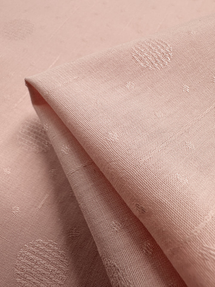 The Textured Cotton in Silver Pink by Super Cheap Fabrics, measures 143cm and showcases an extra lightweight 100% cotton material with a smooth finish. Featuring subtle dot and small cross patterns, it gently folds into a beautifully layered look.