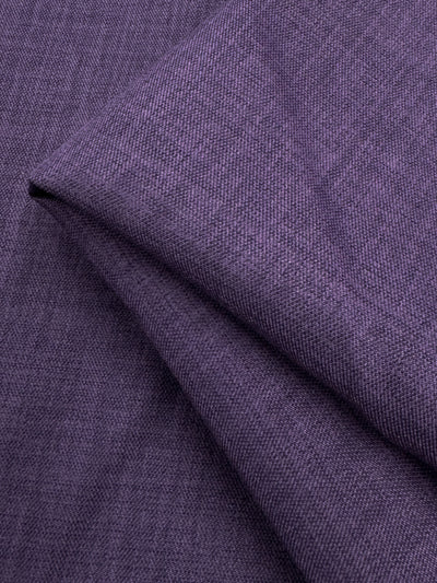 A close-up of Super Cheap Fabrics' Twill Suiting - Wineberry - 150cm reveals fine threads and diagonal creases, highlighting the fabric's signature textured pattern and versatile diagonal twill weave.