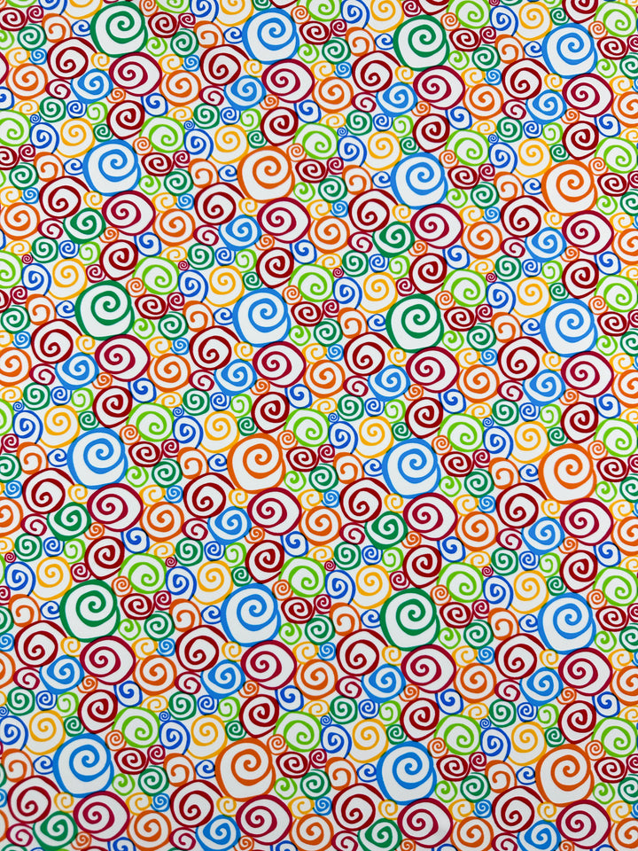 The Printed Nylon Lycra - Swirly - 155cm by Super Cheap Fabrics features an abstract pattern of multicolored spirals in red, blue, green, and yellow on a white background. The closely arranged spirals slightly overlap, creating a vibrant and visually stimulating design. This high-quality print is ideal for multi-use purposes on soft fabric.