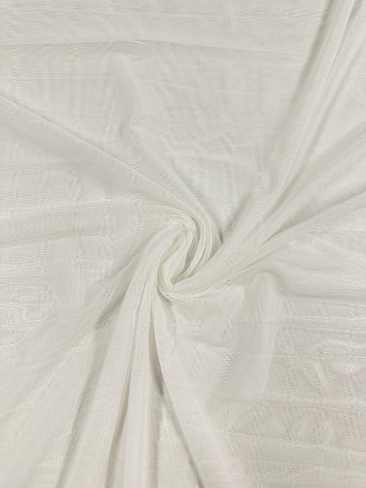 A close-up shows a 145cm Plain Mesh in pale beige with a textured ivory hue from Super Cheap Fabrics. Draped in soft folds with a central twist, this lightweight polyester appears airy and delicate, featuring faint horizontal lines.