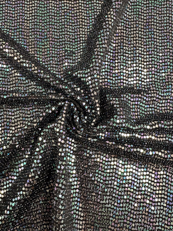 Close-up of black and multi fabric with holographic sequins arranged in a grid pattern. The medium to heavy weight Designer Sequins - Disco - 145cm from Super Cheap Fabrics is gathered in the center, creating folds that highlight its iridescent, reflective properties. Made from 100% polyester fabric.