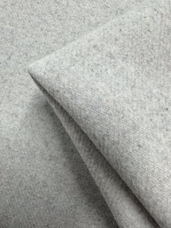 A close-up of Super Cheap Fabrics’ Wool Cashmere - Silver Marle (150cm) shows its luxurious softness, thick texture, and slightly fuzzy silver-gray surface with a corner folded over.