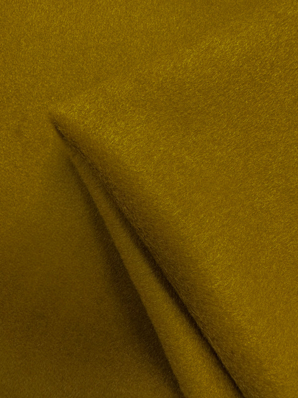 Close-up of Super Cheap Fabrics' Wool Cashmere in Amber Green (150cm), showcasing its soft, textured surface with visible folds and a luxurious, slightly fuzzy finish.