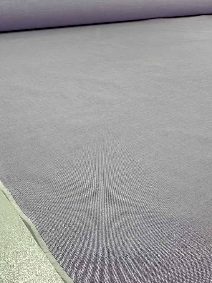 A close-up of Super Cheap Fabrics' Oxford Cotton in Baby Lavender (146cm) highlights its smooth, even surface and detailed weave, showcasing the soft cotton texture of this light to medium weight fabric.