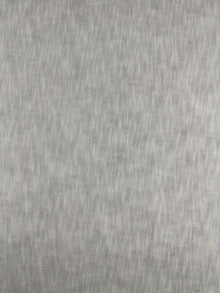 The "Basket Dyed Cotton - Dove" from Super Cheap Fabrics is a grey textured fabric characterized by a subtle twill weave pattern, incorporating light and dark variations that produce a soft, mottled effect. This 140cm upholstery fabric maintains a smooth, uniform appearance across the surface.