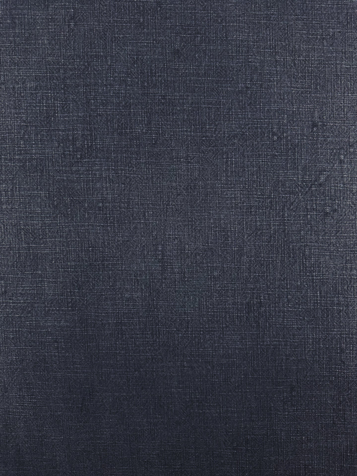 The Basket Dyed Cotton - Navy from Super Cheap Fabrics features a heavyweight fabric surface with a subtle grid-like pattern and variations in color and texture. This material, resembling denim or canvas, displays a slightly rough finish in a rich navy hue, making it ideal for upholstery projects.