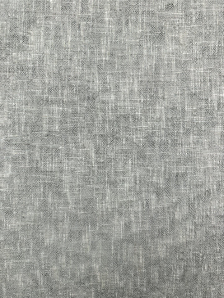 A detailed view of the Basket Dyed Cotton - Moonstruck fabric from Super Cheap Fabrics reveals a crisscross pattern with intricate twill weaving. Made from 100% cotton, this material features a subtle blend of light gray tones and is 140cm wide.