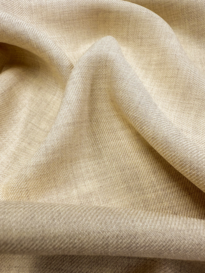 Close-up of the Linen Blend - Banana Crepe from Super Cheap Fabrics, showcasing its soft, beige texture with gentle folds. This 142cm material is lightweight and woven, subtly reflecting light across its surface.