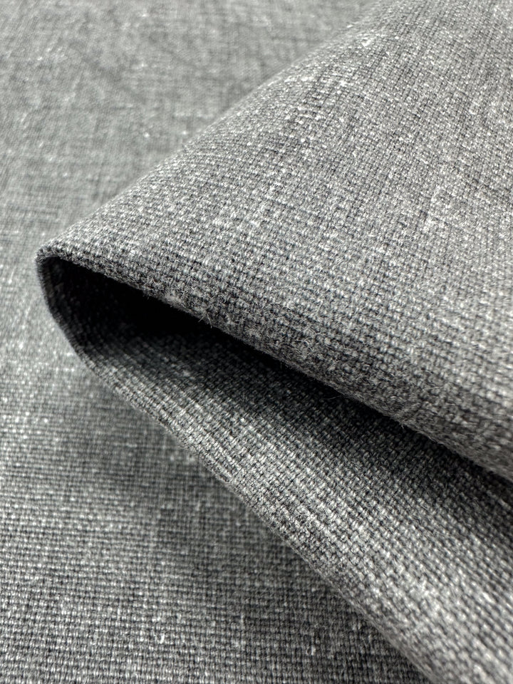 Close-up of Super Cheap Fabrics' Upholstery Canvas in Silver, 140cm. The heavyweight cotton fabric exhibits a textured twill weave with subtle shading variations, ideal for upholstery projects.