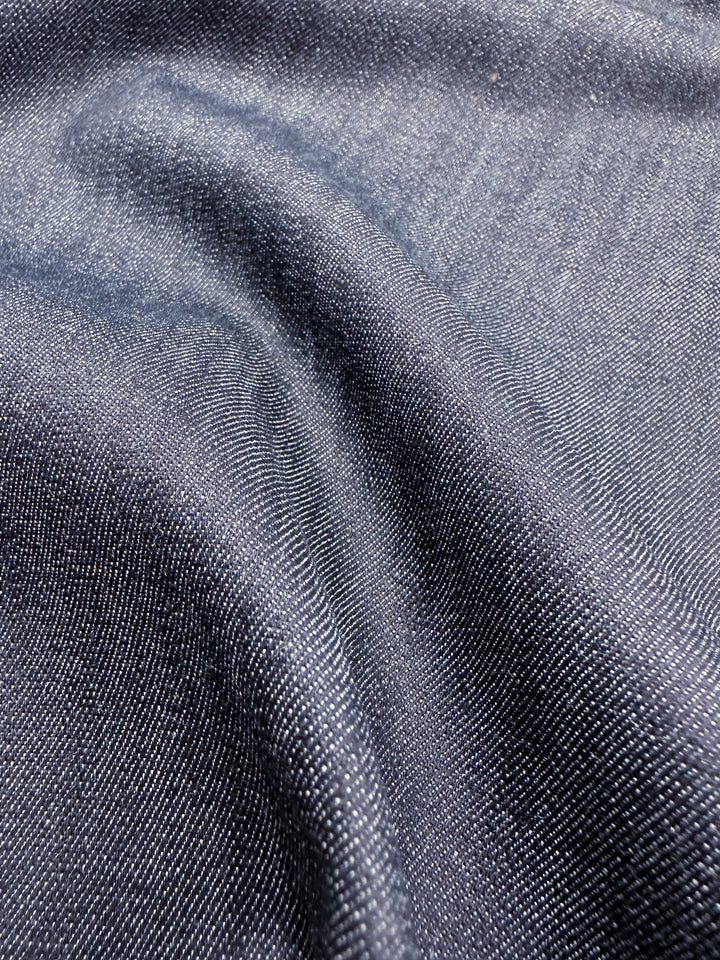 Close-up of the Stretch Denim - Black Iris - 140cm by Super Cheap Fabrics, showcasing the visible texture and subtle color variation of its dark ring-spun cotton weave.