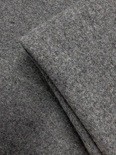 Close-up of two pieces of Super Cheap Fabrics’ Melton Wool - Charcoal - 150cm overlapping, highlighting the soft texture and fibers perfect for outerwear and heavyweight wool projects.