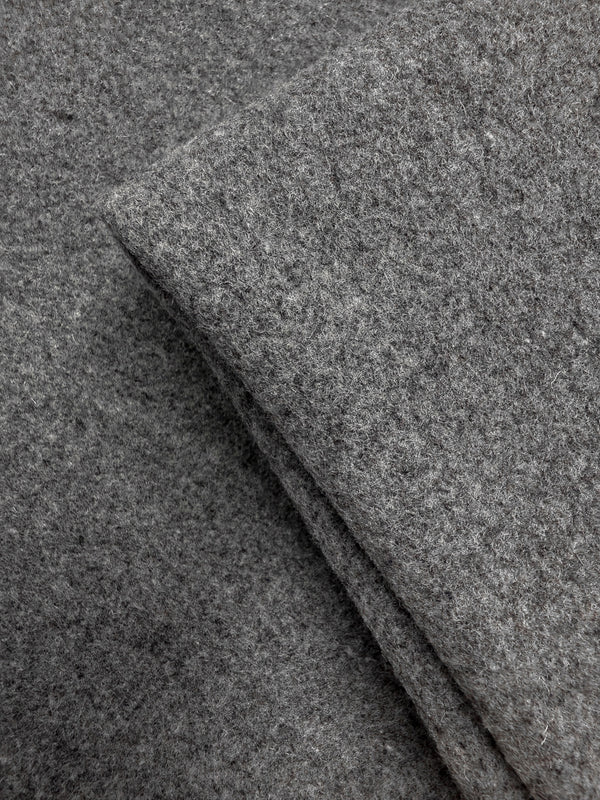 Close-up of two pieces of Super Cheap Fabrics’ Melton Wool - Charcoal - 150cm overlapping, highlighting the soft texture and fibers perfect for outerwear and heavyweight wool projects.