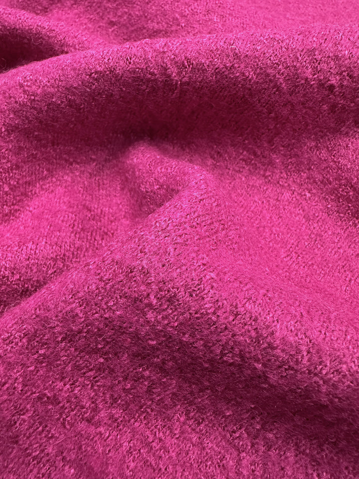 Close-up of Super Cheap Fabrics' Boiled Wool in Fuchsia Red, showcasing a soft, plush texture with gentle folds and a vibrant hue.