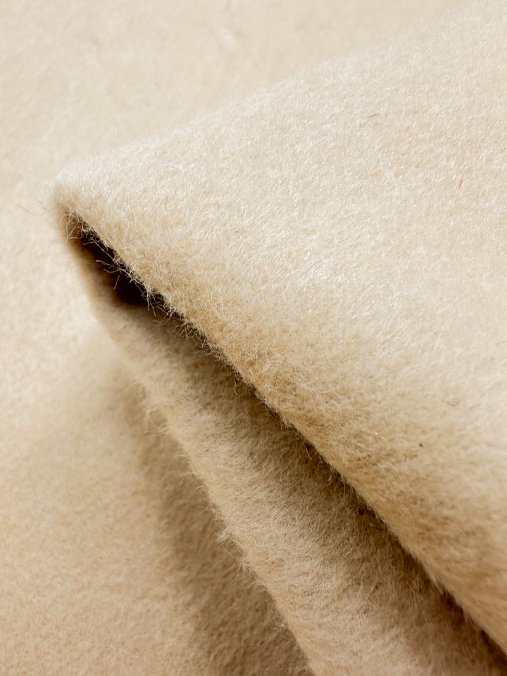 A close-up of Wool Cashmere - Gray Sand fabric by Super Cheap Fabrics showcases its soft, fuzzy texture and elegant warmth, reminiscent of cashmere.