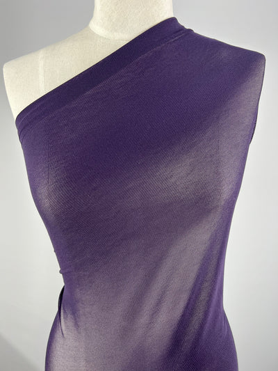 A mannequin displays Super Cheap Fabrics' Plain Mesh in Vintage Violet, featuring its smooth, elegant lightweight polyester texture against a plain gray background.