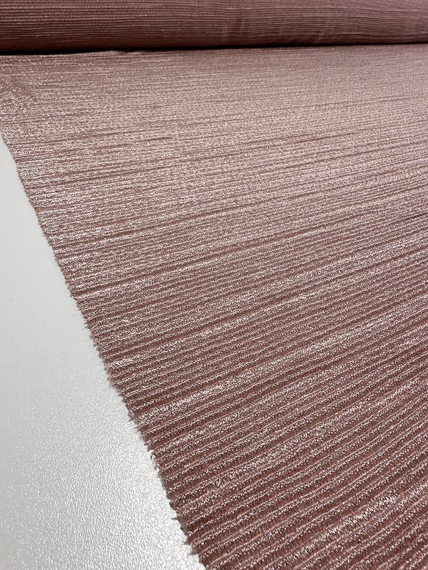 A close-up image displays a textured, medium to heavy weight knit fabric called "Metallic Knit - Blush - 150cm" by Super Cheap Fabrics, featuring horizontal ribbing in a muted pinkish-brown hue. The blush fabric is rolled out on a flat surface, with the selvage edge visible on the left side of the image.