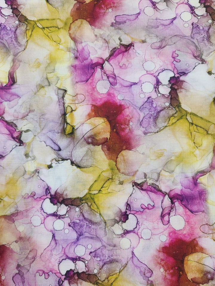 Discover the Designer Cotton - Blist from Super Cheap Fabrics, showcasing a striking abstract watercolor pattern with vibrant splashes of purple, pink, yellow, and white. The swirling and overlapping hues blend seamlessly to create a dynamic and artistic visual effect on premium cotton fabric. This 150cm wide material is ideal for luxury sewing projects where an engaging aesthetic is essential.